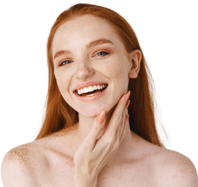 Close-up of young beautiful redhead woman smiling at at front, touching perfect clean skin on face and looking happy